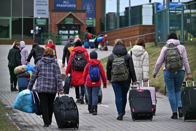 People, pass through Medyka border crossing in Poland heading back into war-torn Ukraine on April 06, 2022 in Medyka, Poland. Photo by Jeff J Mitchell/Getty Images.