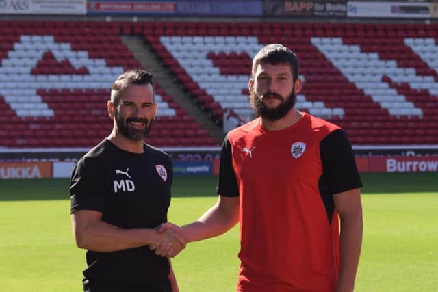 In his capacity with the academy, Martin Devaney welcomes new signing Gerry McDonagh to Oakwell. (Picture: Barnsley FC)