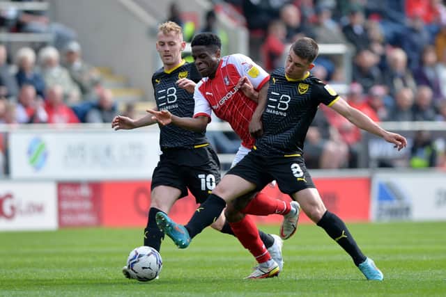 Getting tight: Rotherham United’s Chiedozie Ogbene is squeezed out by Oxford’s Mark Sykes and Cameron Brannagan but hopes not to be in the promotion race. (Picture: Bruce Rollinson)