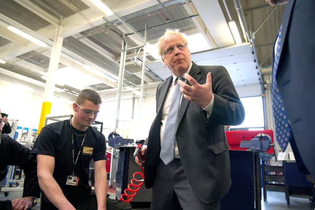 Prime Minister Boris Johnson holds a rivet gun during a campaign visit to Burnley College Sixth Form Centre in Burnley yesterday