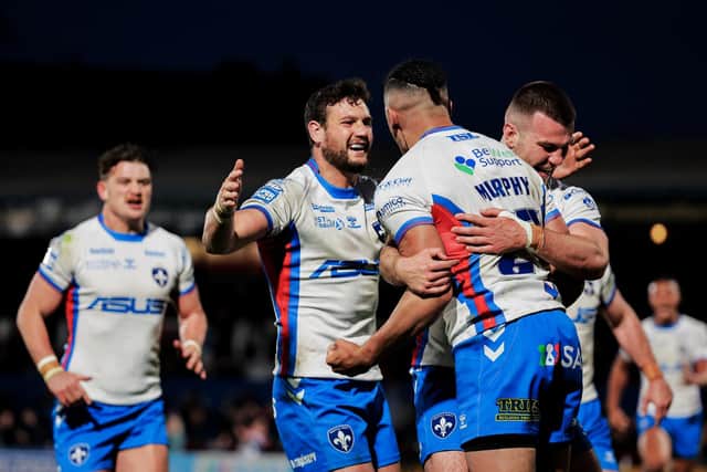 Lewis Murphy is mobbed by his Wakefield team-mates after scoring against Huddersfield. (Picture: SWPix.com)