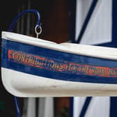 The restored model of a lifeboat that is a collection box at the Whitby Lifeboat Museum