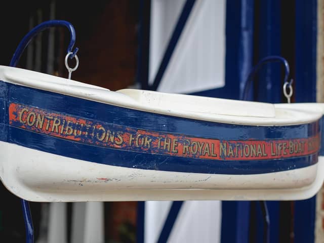 The restored model of a lifeboat that is a collection box at the Whitby Lifeboat Museum