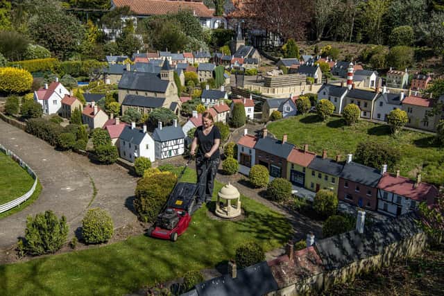 Gardener Sophie Revitt cuts the grass as final preparations are made at Bondville Model Village at Sewerby, Bridlington for their reopening for the start of the season on May 1st. . Picture Tony Johnson