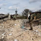 A Ukranian soldier looks into a crater left by a Russian bomb strike in the village of Yatskivka, eastern Ukraine; Russia’s focus now seems to be on the Donbas region. Picture: RONALDO SCHEMIDT/AFP/Getty.