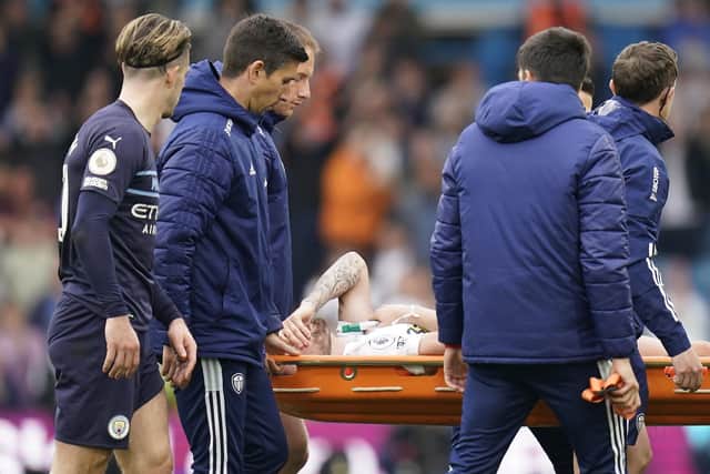 Leeds United's Stuart Dallas is stretchered off after picking an injury during the Premier League match at Elland Road, (Picture: PA)