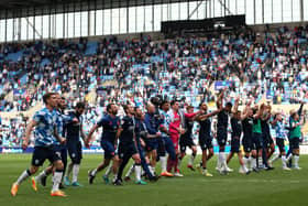 Time to celebrate: Huddersfield Town fans celebrate with the travelling fans after securing a 2-1 win over Coventry in their final away game of the Championship’s regular season. (Picture: Nigel French/PA)