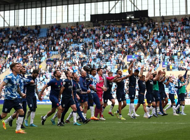 Time to celebrate: Huddersfield Town fans celebrate with the travelling fans after securing a 2-1 win over Coventry in their final away game of the Championship’s regular season. (Picture: Nigel French/PA)