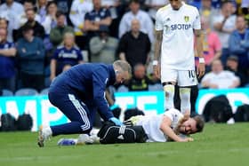 INJURY: Stuart Dallas is treated in the defeat at home to Manchester City