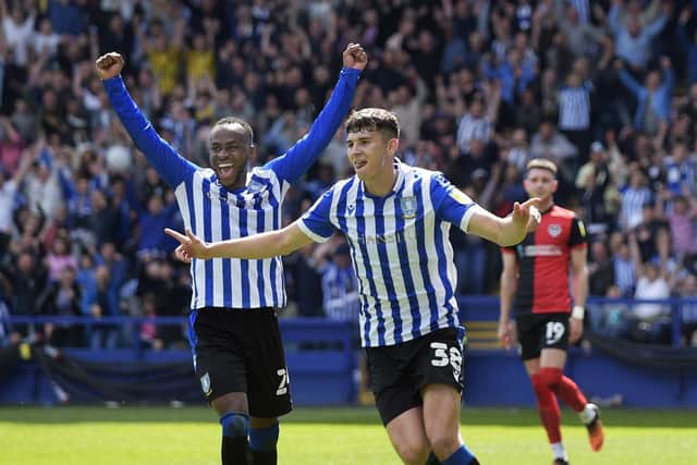 PLAY-OFFS SEALED: Jordan Storey celebrates with Saido Berahino after scoring for Sheffield Wednesday against Portsmouth on Saturday. Picture: Steve Ellis.