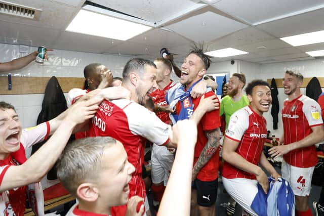 Rotherham United's Daniel Barlaser (right) celebrates with his team-mates in the dressing room. Picture: PA.