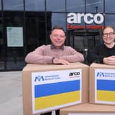 Andy Owen, Head of Healthcare, and Anna Harvatt, Community Engagement Manager, with boxes of PPE for Ukraine.