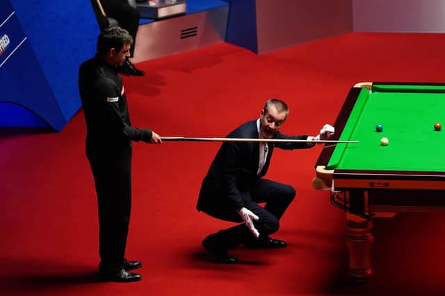 Check: Ronnie O'Sullivan has a discussion with referee Olivier Marteel during his win over Judd Trump. Picture: Zac Goodwin/PA Wire.