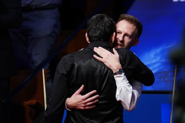 Ronnie O'Sullivan embraces Judd Trump after winning the Betfred World Snooker Championship.