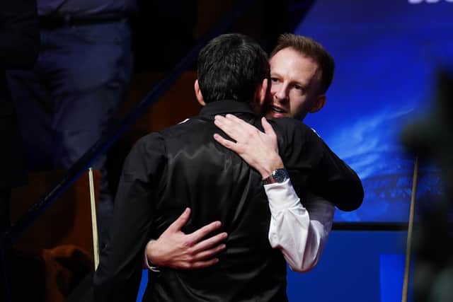 England's Ronnie O'Sullivan embraces England's Judd Trump after winning the Betfred World Snooker Championship (Picture: PA)