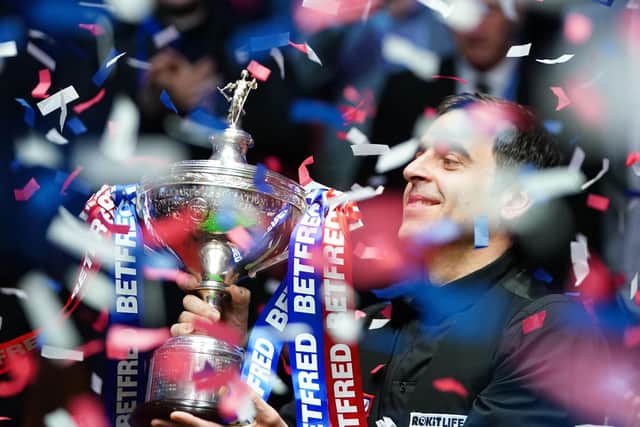 Ronnie O'Sullivan celebrates with the trophy after winning a seventh world title (Picture: PA)