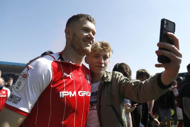 Rotherham United's Michael Smith (left) poses for a photo with a fan after the final whistle at Gillingham. Picture: PA.