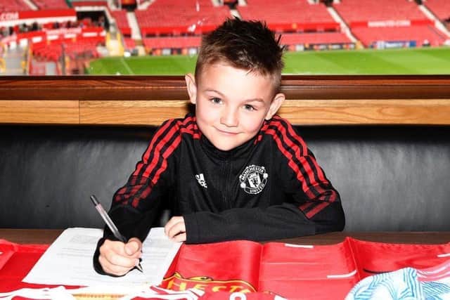 Jack Maguire signing his contract with Manchester United