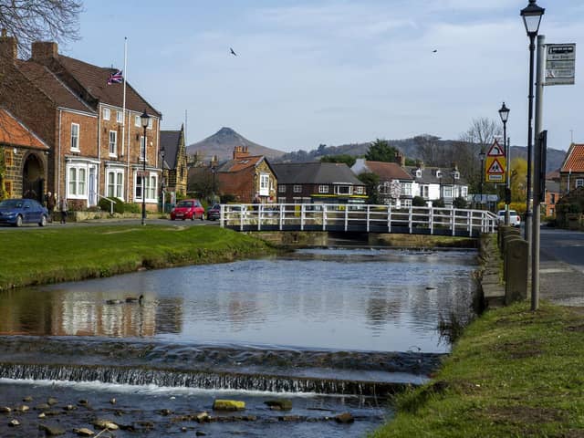 Roseberry Topping peaking over Great Ayton with the River Leven flowing through the village. Pic: Tony Johnson.