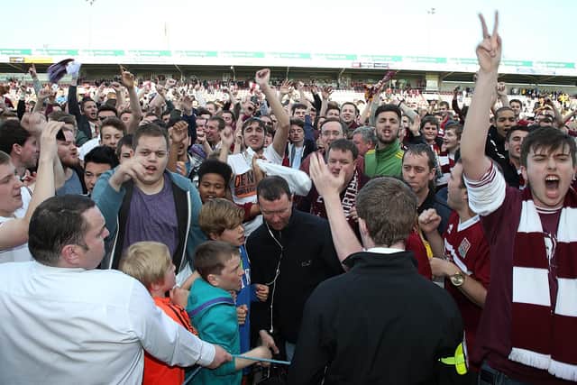WE ARE STAYING UP: Northampton Town fans celebrate at the end of the game against Oxford United after victory secured their league status on May 3, 2014 Picture: Pete Norton/Getty Images