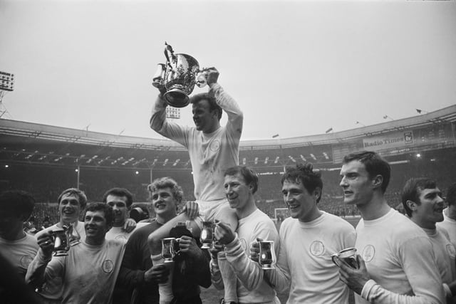 Leeds United FC captain Billy Bremner (1942 - 1997) holds aloft the cup after winning the Football League Cup Final against Arsenal FC at the old Wembley Stadium. (Photo by Larry Ellis/Daily Express/Hulton Archive/Getty Images)