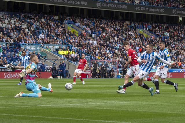Huddersfield Town's Harry Toffolo slips the ball past Bristol City goalkeeper Daniel Bentley to score the hosts' first goal  Picture: Tony Johnson
