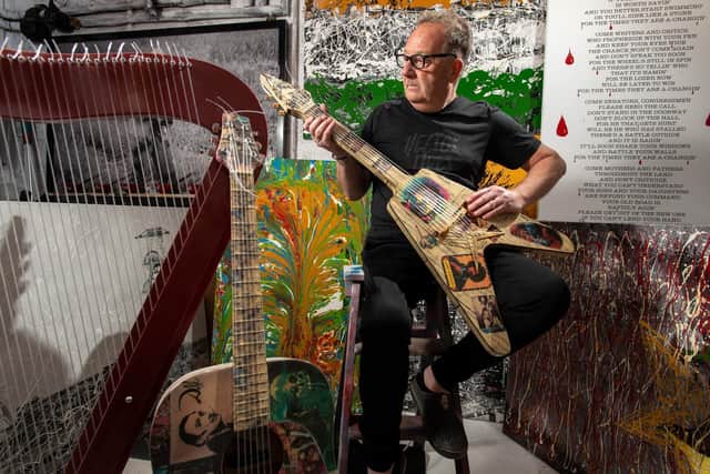 Artist John Young with some of his art work and guitars decorated to celebrate Salvador Dali and Jimi Hendrix. Picture Bruce Rollinson