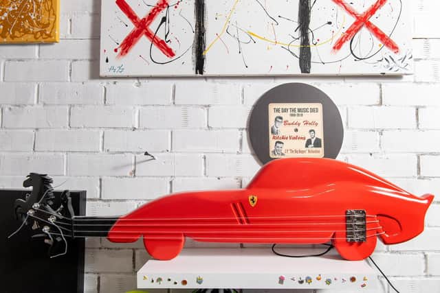 Ferrari inspired car shaped guitar. Artist John Young with some of his art work and guitars decorated to celebrate Prince, Jim Hendrix and Salvador Dali. Picture Bruce Rollinson