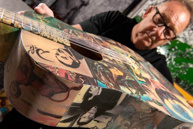 Artist John Young with some of his art work and a guitar decorated to celebrate Salvador Dali .  Picture Bruce Rollinson