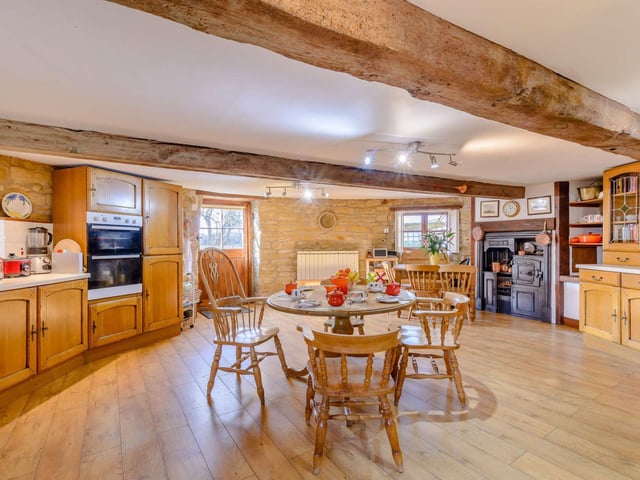 The large kitchen and breakfast room, with plenty of storage plus an orignal cast-iron oven and stove.