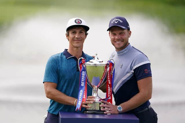 Denmark's Thorbjorn Olesen celebrates winning with the trophy and Danny Willett (right) after day four of Betfred British Masters at The Belfry (Picture: Zac Goodwin/PA Wire)