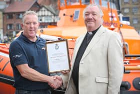 Reverend Canon David Smith (left) being presented with his certificate of service in 2016 from former Coxswain Mike Russel.
Picture: RNLI/Ceri Oakes