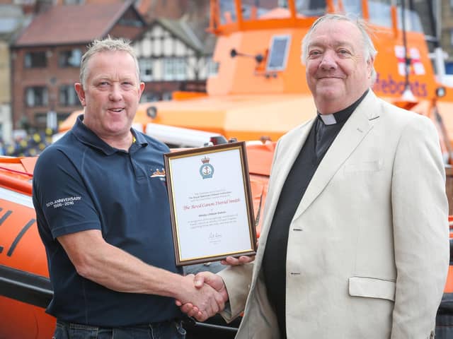 Reverend Canon David Smith (left) being presented with his certificate of service in 2016 from former Coxswain Mike Russel.
Picture: RNLI/Ceri Oakes