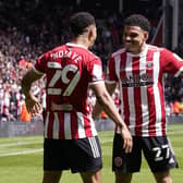 PLAY-OFF PUSH: Sheffield United's Iliman Ndiaye (left) celebrates scoring his side's second goal against Fulham with team-mate Morgan Gibbs-White. Both players make the cut for this week's Team of the Week. Picture: PA Wire.