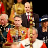 The Prince of Wales and the Duchess of Cornwall with the Duke of Cambridge proceed behind the Imperial State Crown through the Royal Gallery during the State Opening of Parliament