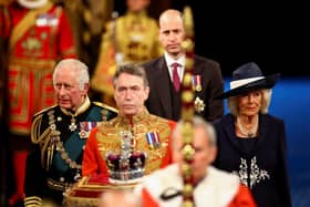 The Prince of Wales and the Duchess of Cornwall with the Duke of Cambridge proceed behind the Imperial State Crown through the Royal Gallery during the State Opening of Parliament