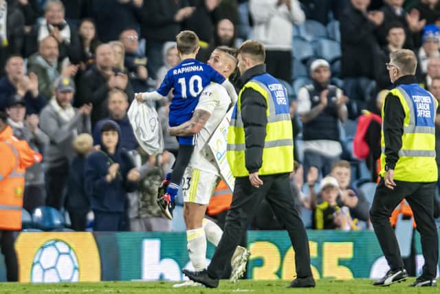 Leeds United's Kalvin Phillips carries a young fan off the pitch at the end of the Chelsea game.  Picture: Tony Johnson