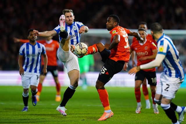 Huddersfield Town's Tom Lees (left) and Luton Town's Cameron Jerome battle for the ball. Picture: PA