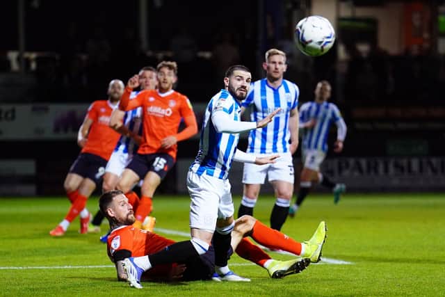 WE GO AGAIN: Luton Town's Sonny Bradley (left) and Huddersfield Town's Pipa battle for the ball at Kenilworth Road Picture: Adam Davy/PA