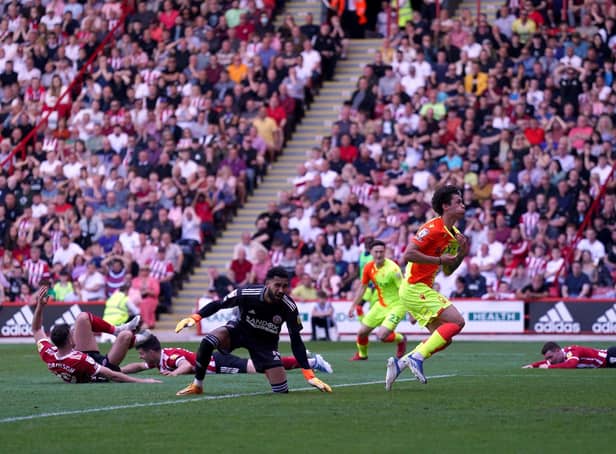 TRAIL OF DISASTER: Three Sheffield United players lie on the ground after Nottingham Forest's Brennan Johnson celebrates scoring his side's second goal of the game at Bramall Lane, Sheffield. Picture: Tim Goode/PA