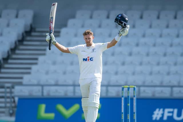 Yorkshire's Joe Root celebrates his century against Lancashire against the backdrop of largely empty stands (Picture: SWPix.com).