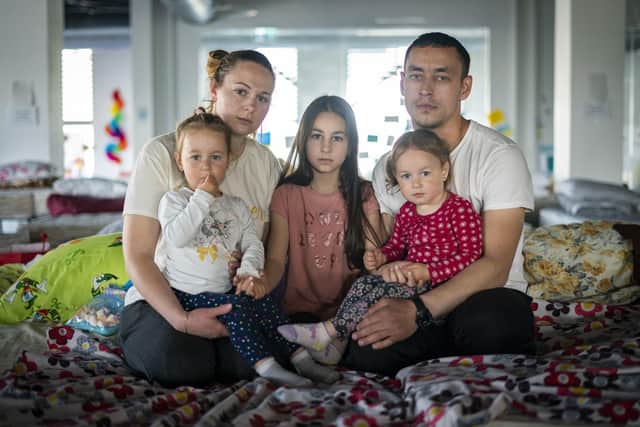 Ukrainian refugees Elena Sidorova, 30, her husband Vladimir Sidorova, 31, and their daughters Polina (centre), aged 9, and twins Eva (left) and Zlata (right), aged 2, who fled their home in Odesa, at the Egros refugee transit centre in Iasi, Romania.