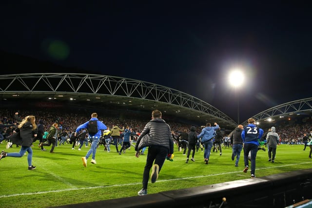 Fans rush onto the pitch at full time