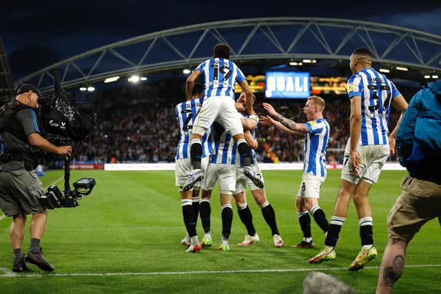 WEMBLEY WAY: Huddersfield players celebrate their vital goal against Luton Town on Monday night. Picture: Getty Images.