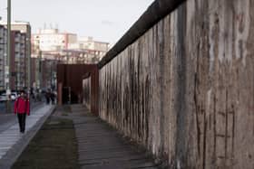 A visitor walks along the Berlin Wall memorial at Bernauer Strasse on February 5, 2018 in Berlin, Germany. Picture: Carsten Koall/Getty.