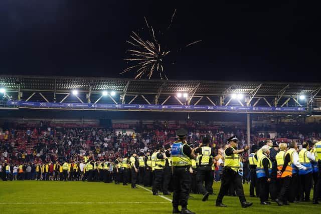 A strong police presence on the City Ground pitch at full-time after the Championship play-off semi-final between Nottingham Forest and Sheffield United Picture: Mike Egerton/PA