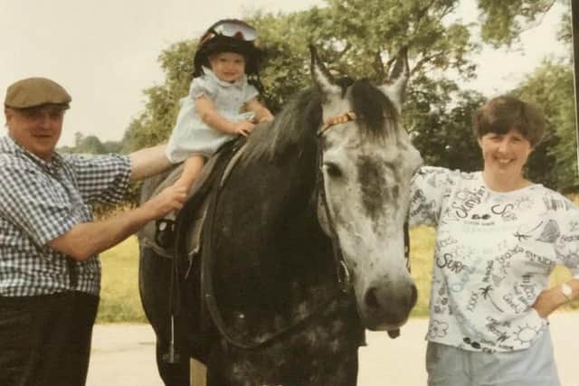Famous family: Joanna Mason gets an early experience of being on horse back with her grandad Mick Easterby, left and her mum Sue, a former point to point rider. Picture: Joanna Mason.