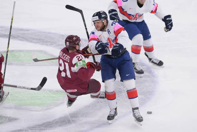 Sheffield Steelers' Rob Dowd puts a mid-ice hit on Latvia's Rudolfs Balcers. Picture: Dean Woolley/IHUK