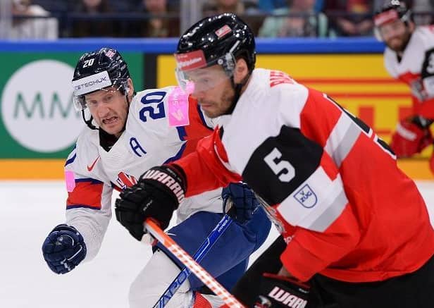 TOUGH NIGHT: Jonathan Phillips battles with Austria's Thomas Raffl in the Group B relegation decider in Tamper, Finland. Picture: Dean Woolley/IHUK.