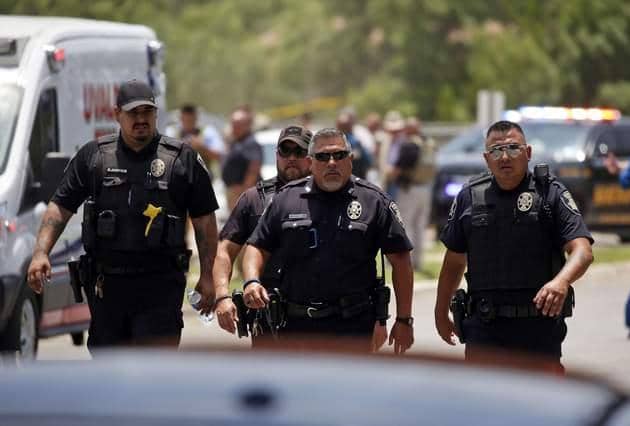 Police walk near Robb Elementary School following a shooting in Uvalde, Texas. (AP)